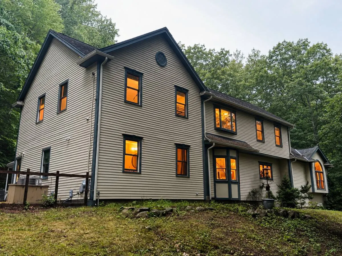 Southborough Garden Retreat among tall trees, its windows lit